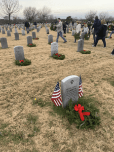 When placing a wreath on each gravesite, the volunteer announced the name and details on each gravestone.